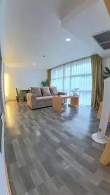 a large living room with a couch and a table at The Kris Residence Two Bedrooms Apartment in Patong Beach