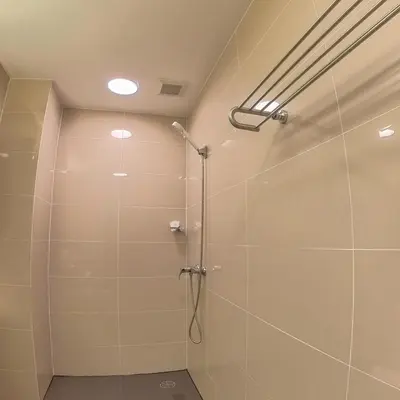 a shower with a glass door in a bathroom at The Kris Residence Two Bedrooms Apartment in Patong Beach