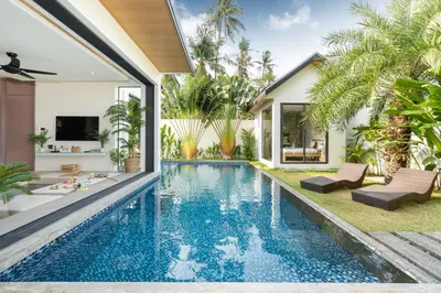 an infinity pool in the backyard of a villa at Villa Kalliste Phuket - Lush Garden Escape in Nai Yang Beach