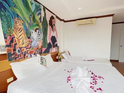 a bedroom with a bed with flowers on it at Lanting House Phuket in Patong Beach