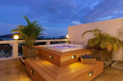 a hot tub on a balcony with two palm trees at V270 Best View In Phuket Hot Tub Great Location in Rawai Beach