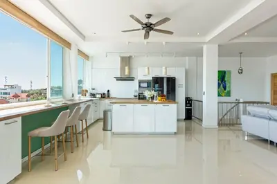 a kitchen with white cabinets and a ceiling fan at V270 Best View In Phuket Hot Tub Great Location in Rawai Beach