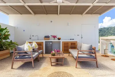 a living room with two chairs and a table at V270 Best View In Phuket Hot Tub Great Location in Rawai Beach