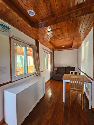 a living room with a table and a couch at Tiny 1-2 in Rawai Beach