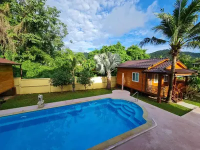 a swimming pool in front of a house at Tiny 1-2 in Rawai Beach