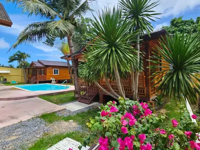 a villa with a pool and a house at Tiny 1-2 in Rawai Beach