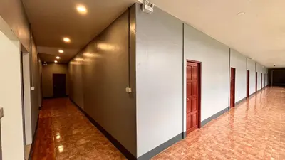 a hallway with white walls and a door at Fahsai Hostel in Ao Nang Beach