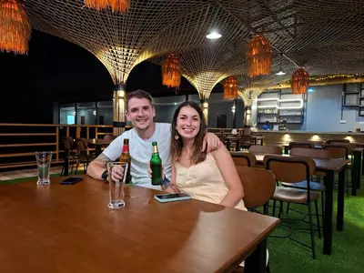 a man and woman sitting at a table in a restaurant at Fahsai Hostel in Ao Nang Beach