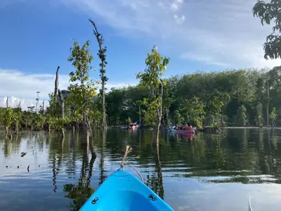 a group of people in a kayak on a river at Fahsai Hostel in Ao Nang Beach