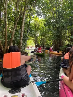 a group of people kayaking down a river at Fahsai Hostel in Ao Nang Beach