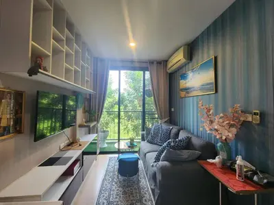 a living room with a couch and a table at Stylish condo near Boat Avenue LAGUNA in Bang Tao Beach