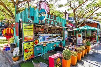 a food stand with people sitting at tables in front of it at Stylish condo near Boat Avenue LAGUNA in Bang Tao Beach