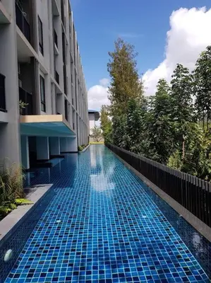 a swimming pool in the middle of a building at Stylish condo near Boat Avenue LAGUNA in Bang Tao Beach