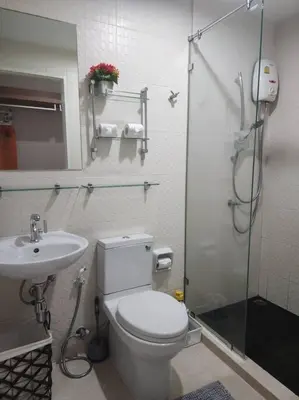a bathroom with a toilet and a sink and a shower at Stylish condo near Boat Avenue LAGUNA in Bang Tao Beach