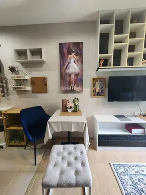 a living room with a table and a tv at Stylish condo near Boat Avenue LAGUNA in Bang Tao Beach