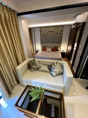 a living room with a couch and a bed at Apartment in Mida Grande Surin in Surin Beach