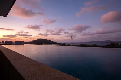 a view of a large body of water at sunset at Apartment in Mida Grande Surin in Surin Beach