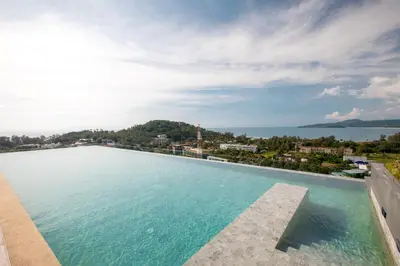 a large swimming pool with a view of the water at Apartment in Mida Grande Surin in Surin Beach