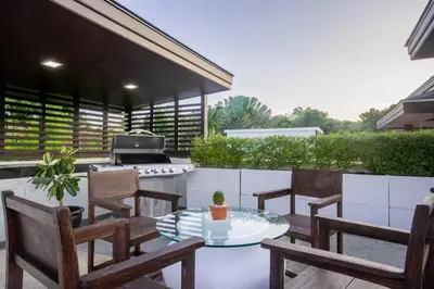 a patio with a table and chairs and a grill at Naiharn Pool Villa Number 5 in Rawai Beach