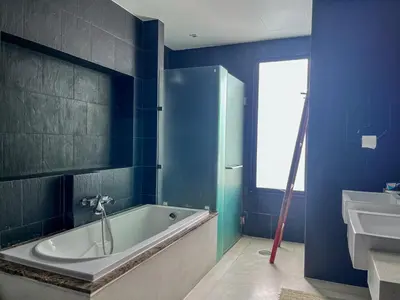 a blue bathroom with a tub and a sink at Naiharn Pool Villa Number 5 in Rawai Beach