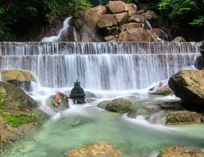a waterfall in the middle of a river at Bayok 10 - 2 Bedroom Villa Near Kathu Waterfall in Ban Huai Luk (1)