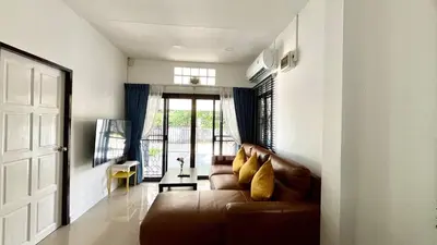 a living room with a brown couch and a window at Bayok 10 - 2 Bedroom Villa Near Kathu Waterfall in Ban Huai Luk (1)