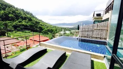 a swimming pool on the balcony of a house at Villa Patong in Patong Beach