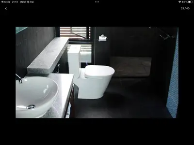 a bathroom with a white sink and a toilet at Villa Patong in Patong Beach