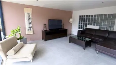 a living room with a couch and a tv at Villa Patong in Patong Beach