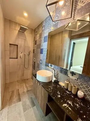 a bathroom with a sink and a mirror and a shower at Poolside 1 Bedroom Apartment by Renttini in Surin Beach