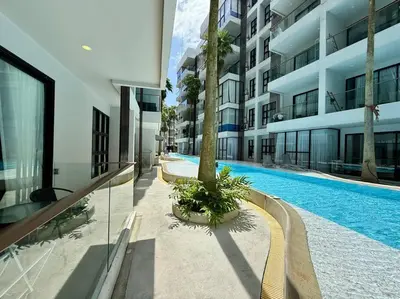 a swimming pool in the middle of a building at Poolside 1 Bedroom Apartment by Renttini in Surin Beach