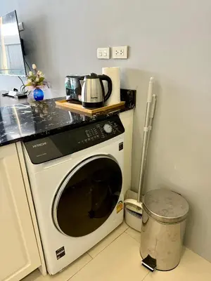 a kitchen with a washing machine in a kitchen at Poolside 1 Bedroom Apartment by Renttini in Surin Beach