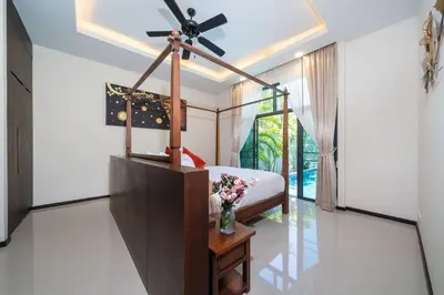 a bedroom with a bed with a ceiling fan at Onyx 2 br private pool Rawai in Ban Saiyuan (1)