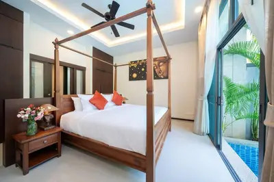 a bedroom with a canopy bed and a pool at Onyx 2 br private pool Rawai in Ban Saiyuan (1)