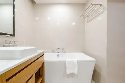 a white bathroom with a sink and a mirror at Apart Close to the Beach Sea view in Rawai Beach