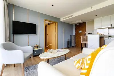 a living room with a couch and a tv at Apart Close to the Beach Sea view in Rawai Beach
