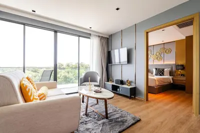 a living room with a couch and a table at Apart Close to the Beach Sea view in Rawai Beach