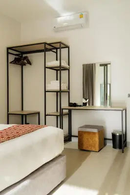 a bedroom with a bed and a mirror at Barringtonia pool villa in Phuket Town