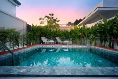 a swimming pool in the backyard of a house at Barringtonia pool villa in Phuket Town