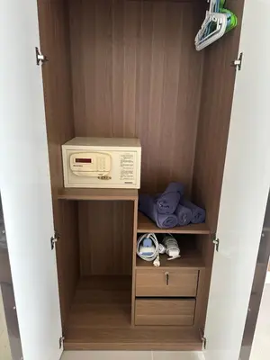 a closet with a box and shoes in it at Patong Tower sea view 2B in Patong Beach