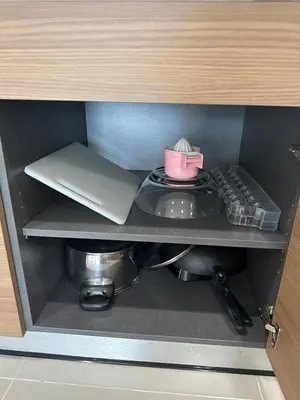 a shelf in a kitchen with a laptop and a table at Patong Tower sea view 2B in Patong Beach