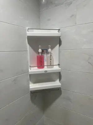 a white shelf in a white tiled bathroom at Patong Tower sea view 2B in Patong Beach