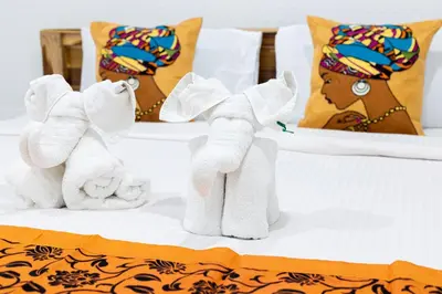 a group of three stuffed animals on a bed at PMS Boutique Patong in Patong Beach