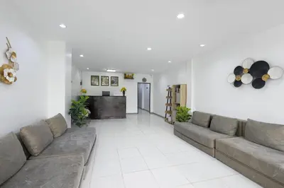 a living room with a couch and a table at PMS Boutique Patong in Patong Beach