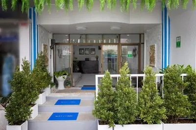 a lobby with blue steps and potted plants at PMS Boutique Patong in Patong Beach