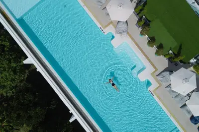 an overhead view of a person swimming in a pool at Chalong Marina Bay View Phuket in Rawai Beach