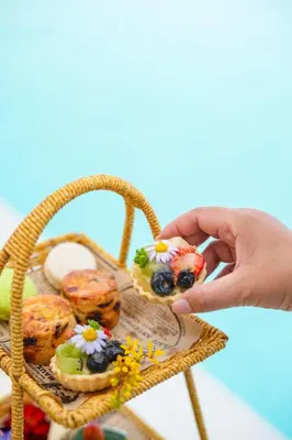 a person holding a plate with food in a basket at Chalong Marina Bay View Phuket in Rawai Beach