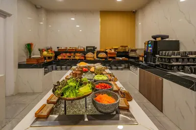 a buffet line with vegetables and fruits in a restaurant at Chalong Marina Bay View Phuket in Rawai Beach