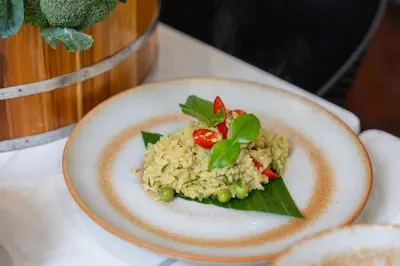 a plate of food with rice and vegetables on a table at Chalong Marina Bay View Phuket in Rawai Beach