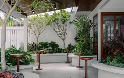 a room filled with lots of plants and stools at Hommory Residence - East Chalong in Phuket Town